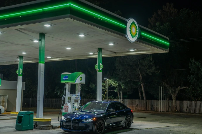 A car at a bp gas station at night.